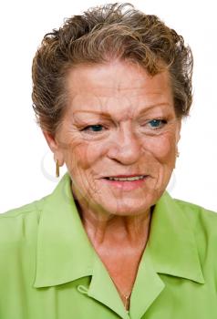 Close-up of a senior woman day dreaming and smiling isolated over white