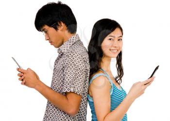 Happy couple text messaging on mobile phones isolated over white