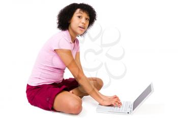 Portrait of a teenage girl using a laptop isolated over white