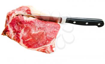 Close-up of a kitchen knife cutting beef isolated over white