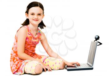 Portrait of a girl using a laptop and posing isolated over white