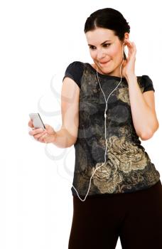 Beautiful woman listening to music on MP3 player isolated over white