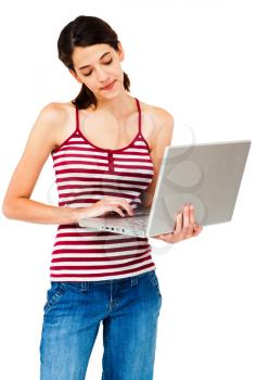Smiling young woman using a laptop isolated over white