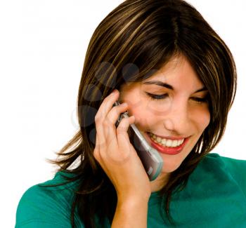 Latin American woman talking on a mobile phone isolated over white