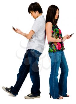 Teenage boy and his sister text messaging on mobile phones isolated over white