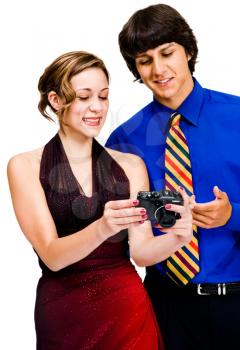 Brother and sister photographing with a camera and smiling isolated over white
