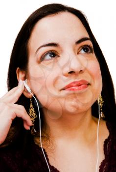 Happy woman listening to music on a MP3 player isolated over white