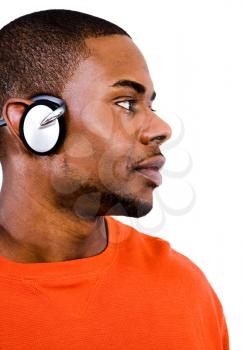 Man wearing headphones and listening to music isolated over white