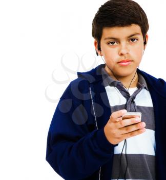 Portrait of a boy listening to an MP3 player isolated over white