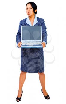 Woman holding a laptop and looking angry isolated over white