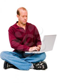 Caucasian mature man using a laptop isolated over white
