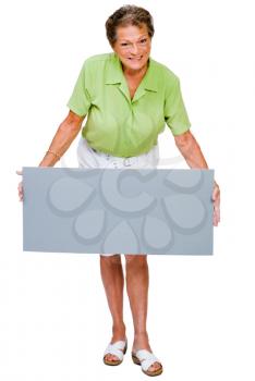 Mature woman showing a placard and smiling isolated over white