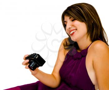 Fashion model holding a camera and smiling isolated over white