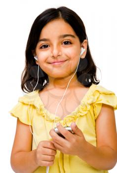 Middle Eastern girl listening to music on a MP3 player isolated over white