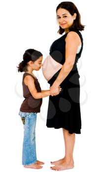 Girl kissing the belly of her mother and smiling isolated over white
