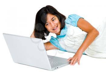 Mixedrace girl using a laptop and smiling isolated over white