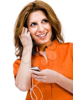 Close-up of a woman listening to music on MP3 player isolated over white
