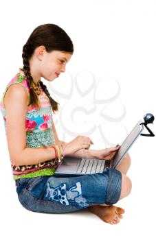 Child using a laptop and smiling isolated over white