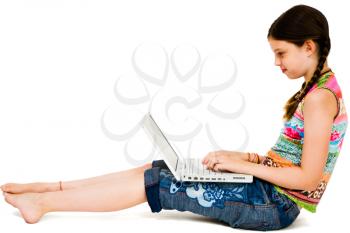 Cute girl using a laptop and smiling isolated over white