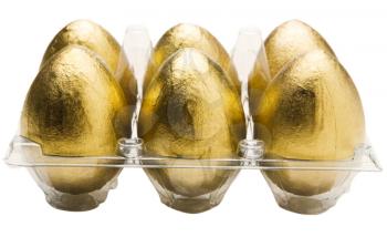Golden eggs in an egg carton isolated over white