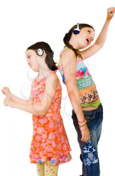Girls listening to music on headphones and smiling isolated over white