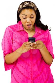 Young woman text messaging on a mobile phone isolated over white