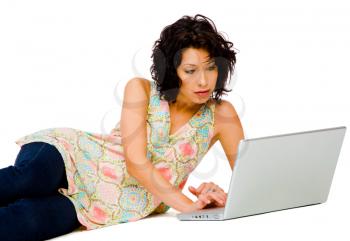 Beautiful woman using a laptop and posing isolated over white