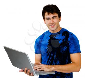 Young man using a laptop and smiling isolated over white