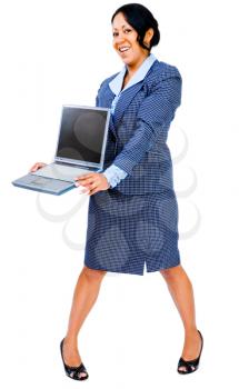 Happy businesswoman holding a laptop and posing isolated over white
