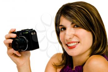 Woman holding a camera and smiling isolated over white