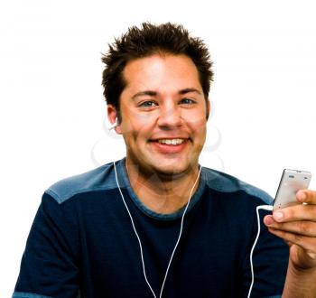 Smiling man listening to music on a MP3 player isolated over white