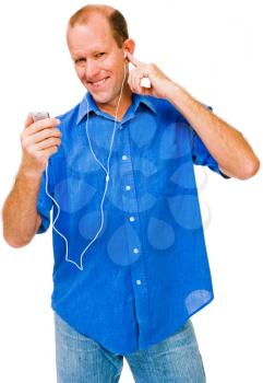 Caucasian man listening to MP3 player and smiling isolated over white