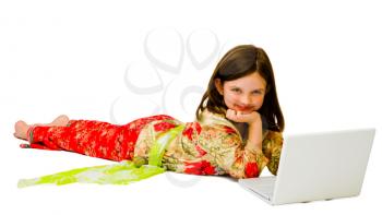Cute girl using a laptop and smiling isolated over white