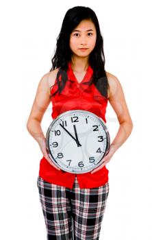 Portrait of a woman showing a clock and posing isolated over white