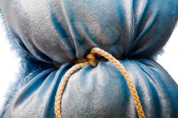 Blue color pillow tied up with a rope isolated over white