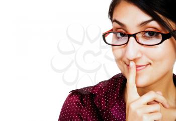 Woman posing with her finger on her mouth and smiling isolated over white