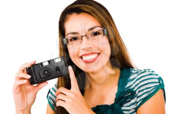 Portrait of a woman photographing with a camera and smiling isolated over white