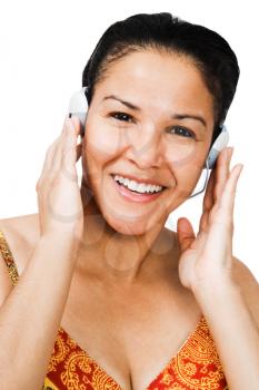 Portrait of a woman listening to music on headphones isolated over white