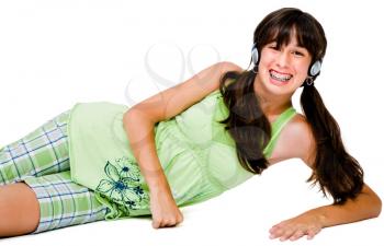 Portrait of a teenage girl wearing headphones and listening to music isolated over white