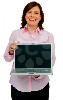 Close-up of a woman showing a laptop and smiling isolated over white