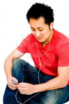 Man listening to music on a MP3 player and smiling isolated over white