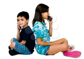 Brother and sister talking on mobile phones isolated over white 