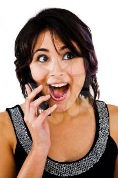 Latin American woman talking on a mobile phone isolated over white