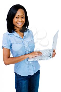 Asian woman using a laptop and smiling isolated over white