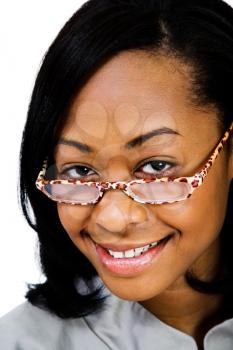 Young woman wearing eyeglasses and smiling isolated over white