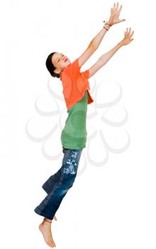 Confident girl jumping and smiling isolated over white