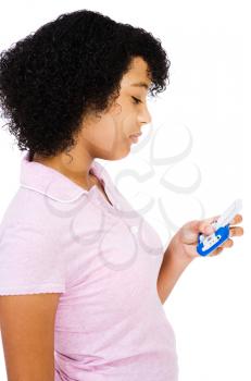 Close-up of teenage girl text messaging on a mobile phone isolated over white