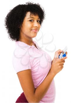 African teenage girl text messaging on a mobile phone isolated over white