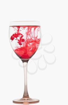 Red color streaks with water in a wine glass