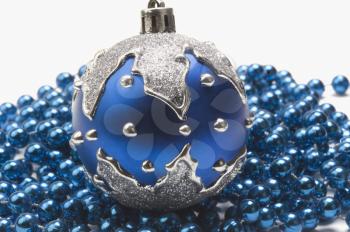 Close-up of blue bauble on string of blue beads